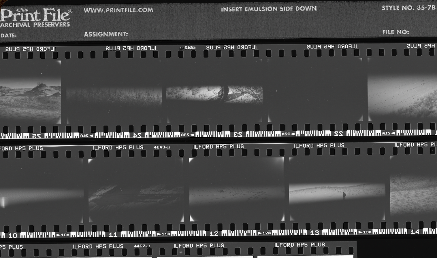 Landscape-oriented black and white contact sheet with road and landscape negatives